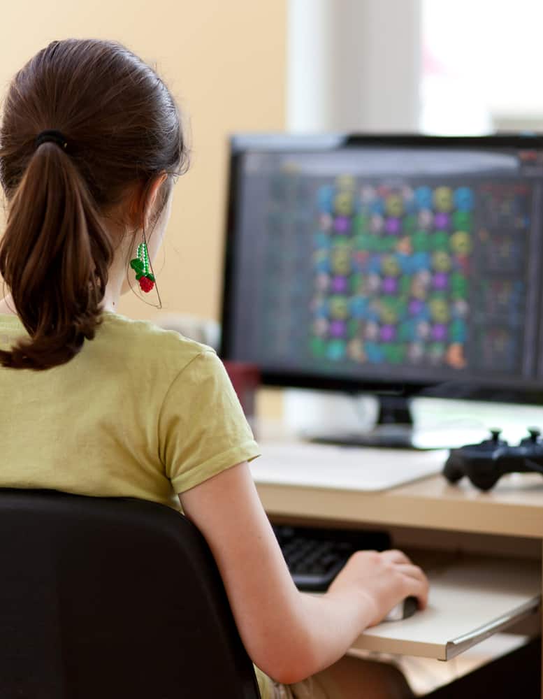 girl playing game on computer