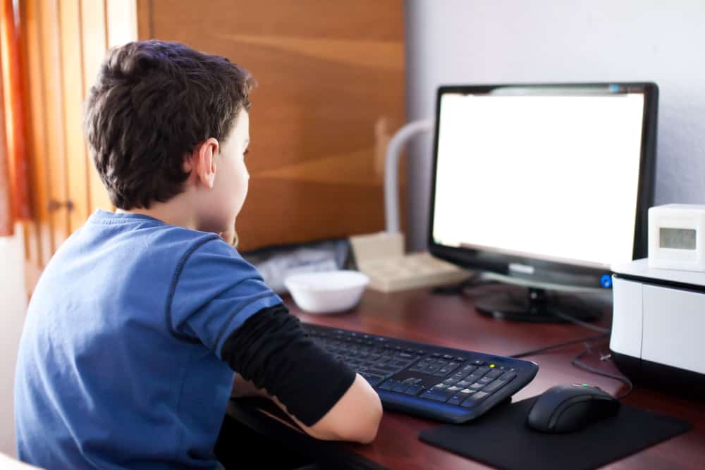 child at computer, doing work